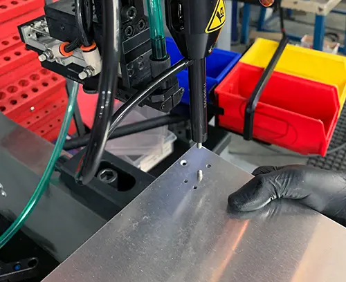 Die Platte befindet sich genau an der Maschine und der Einsatz wird automatisch in Position eingesetzt.